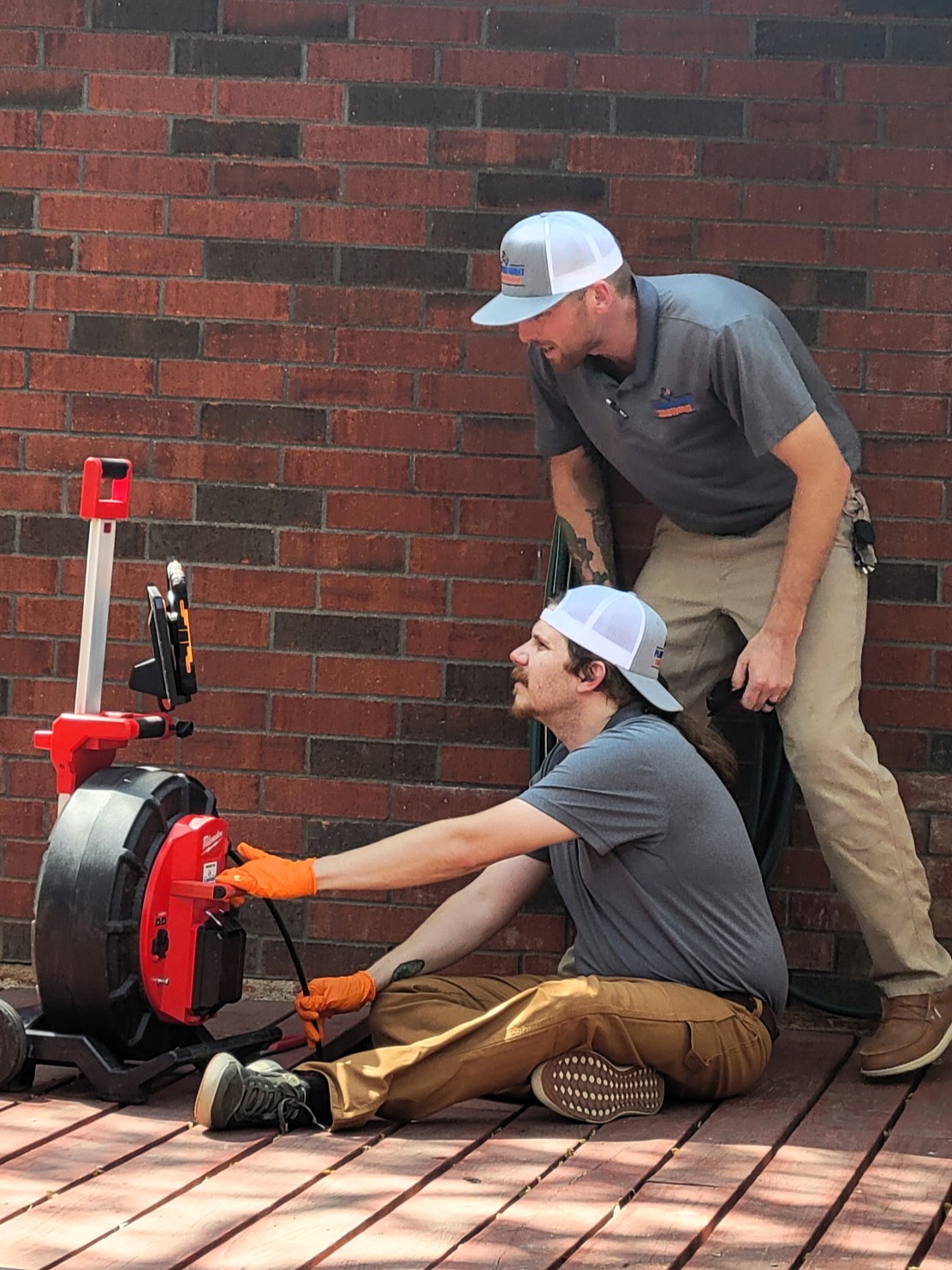Plumbers conducting a sewer camera inspection